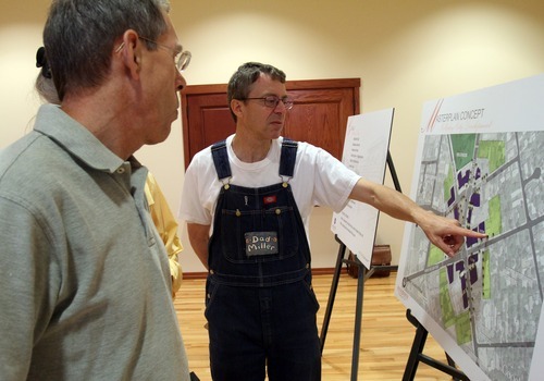 Rick Egan   |  The Salt Lake Tribune

L-R Steve Parks and Barry Miller discuss a proposed design for the Holladay Village Center that would feature ground-level shops topped by offices, Wednesday, August 17, 2011.
