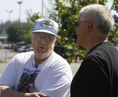 Rick Egan   |  The Salt Lake Tribune
Chuck Cox, left, father of Susan Powell, exchanges words with Steve Powell, father of Joshua Powell, at a shopping center in Puyallup, Wash., on Saturday.