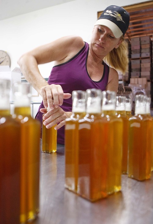 Trent Nelson  |  The Salt Lake Tribune
Kelli Bess seals bottles of honey vinegar at the Slide Ridge farm in Mendon.