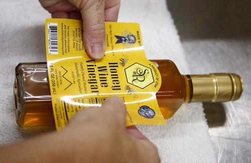 Trent Nelson  |  The Salt Lake Tribune
Labels are put onto jars of honey vinegar at the Slide Ridge farm in Mendon, Utah. Martin James and his family produce a unique Honey Wine Vinegar made from raw honey (from their own hives) and fermented in special process. Similar to balsamic vinegar it can be used as a glaze for meat or drizzled on everything from a salad to ice cream. The honey wine vinegar is getting lots of praise from local experts, who say it's one of the best food products being made in Utah.
Tuesday, August 16, 2011.