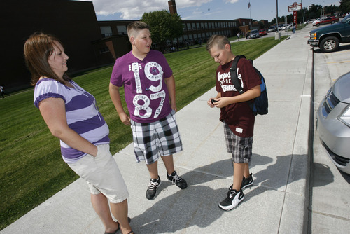 Francisco Kjolseth  |  The Salt Lake Tribune
Sharon Vinson of Sandy picks up her son's V.J., 14, center, and Zach, 12, following their first day  of school at Midvale Middle school  on Monday, August 22, 2011. Middle school is a transition time for seventh-graders and their parents as students are grappling with new academic and social challenges and parents are watching their kids become increasingly independent. It was Zachary's first day of seventh grade.