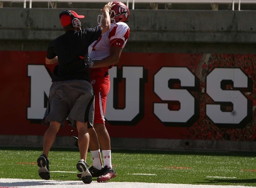 Leah Hogsten  |  The Salt Lake Tribune
University of Utah football team's wide receiver Nick Brown is  congratulated by a staff member for a successful play.  The University of Utah football team scrimmages Saturday, August 20 2011 in Salt Lake City.