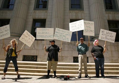 Trent Nelson  |  The Salt Lake Tribune

A rally was held in front of the federal court house Thursday in Salt Lake City to call attention to foreclosures in advance of a hearing over whether to dismiss a proposed class action lawsuit. From left, Heidi Waldera, Wee, Jacob Thomas and T.J. Avis.