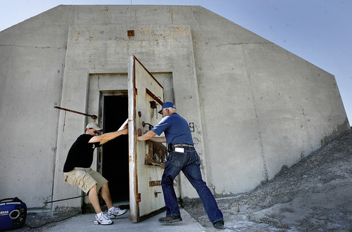 Scott Sommerdorf  |  The Salt Lake Tribune
Tour guides Tom (left) and Jim Petersen open up Bomb Storage Bunker 49 to a tour for the first time, Saturday, August 26, 2011. The Wendover Airfield Museum gave a tour of the secret World War II base facilities which has never been offered before. The tour included rarely open buildings and areas such as: Atomic bomb loading pit Atomic bomb assembly buildings Bomb Storage Bunkers Enlisted Mess hall Aircraft hangars Fire station Enlisted Barracks Norden Bombsight building Officers Mess hall B-29 Enola Gay hangar, Saturday, August 26, 2011.