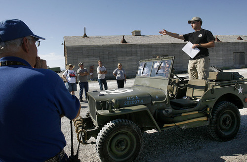 Scott Sommerdorf  |  The Salt Lake Tribune
Tour guide Tom Petersen stands in a vintage jeep to describe the previously secret World War II base facilities which have never been offered on a tour before. The tour included rarely open buildings and areas such as: Atomic bomb loading pit Atomic bomb assembly buildings Bomb Storage Bunkers Enlisted Mess hall Aircraft hangars Fire station Enlisted Barracks Norden Bombsight building Officers Mess hall B-29 Enola Gay hangar, Saturday, August 26, 2011.