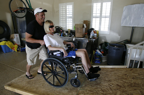 Francisco Kjolseth  |  The Salt Lake Tribune
Stephen Eldredge pushes his wife, Shelli, up the temporary wheelchair ramp in the garage as she recovers from injuries she suffered during a family vacation in Hawaii in June. Shelli was nearly killed in a moped accident. She broke nearly 50 bones, had severe head trauma and at one point was brain dead but is now expected to make a full recovery.