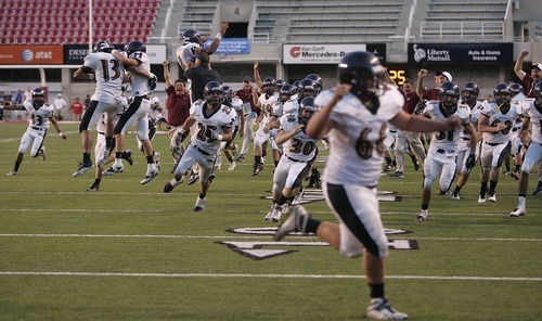 Trent Nelson  |  The Salt Lake Tribune
Herriman players and coaches storm the field after David Christensen pulled in the game-winning pass on a two-point conversion. Herriman vs. Riverton High School football at Rice-Eccles Stadium in Salt Lake City, Utah, Saturday, August 27, 2011.