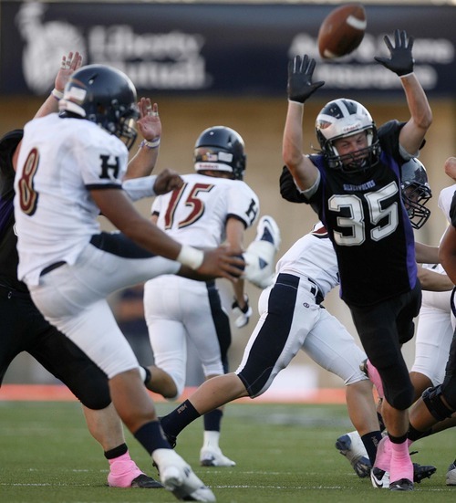 Trent Nelson  |  The Salt Lake Tribune
Riverton's Neal Barlow nearly blocks a punt by Herriman's Tueni Lupeamanu. Herriman vs. Riverton High School football at Rice-Eccles Stadium in Salt Lake City, Utah, Saturday, August 27, 2011.