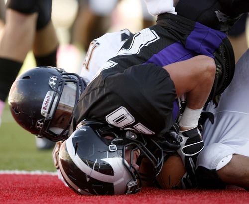 Trent Nelson  |  The Salt Lake Tribune
Riverton's B.J. Newman scores a touchdown as he is brought down in the end zone by Herriman's Francis Bernard. Herriman vs. Riverton High School football at Rice-Eccles Stadium in Salt Lake City, Utah, Saturday, August 27, 2011.