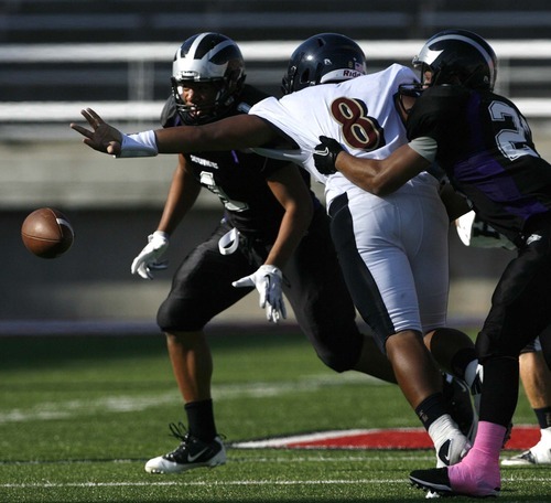 Trent Nelson  |  The Salt Lake Tribune
Herriman's Tueni Lupeamanu is stripped of the ball by Riverton's Dallin Munger. Riverton's Tupou Tua'one Aagard at left. Herriman vs. Riverton High School football at Rice-Eccles Stadium in Salt Lake City, Utah, Saturday, August 27, 2011.