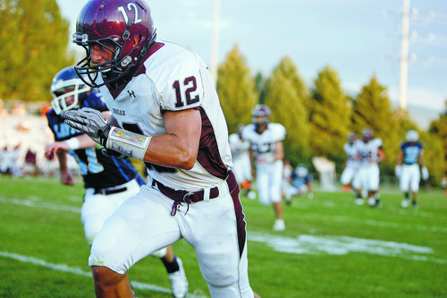 Chris Detrick  |  The Salt Lake Tribune
Jordan's Mason Gajkowski (12) runs for a touchdown during the game at Layton High School Friday August 26, 2011.