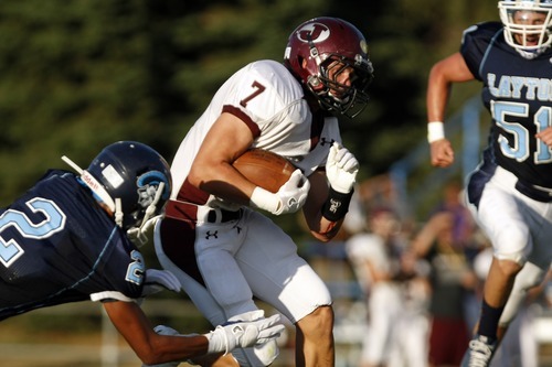 Chris Detrick  |  The Salt Lake Tribune
Jordan's Taylor Loomis (7) runs past Layton's J.T. Anderson (2) during the game at Layton High School Friday August 26, 2011.