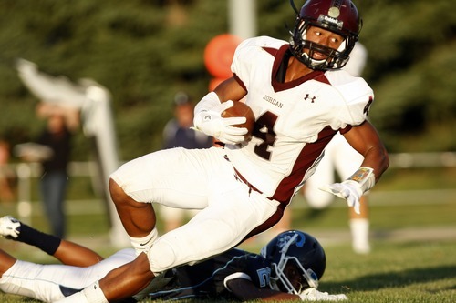 Chris Detrick  |  The Salt Lake Tribune
Jordan's Blake Miller (4) is tackled by Layton's J.T. Anderson (2) during the game at Layton High School Friday August 26, 2011.