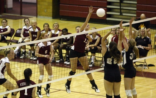 Chris Detrick  |  The Salt Lake Tribune
Viewmont's Carly Grayston (13) spikes the ball as Cottonwood's Jenny Findlay (28) and Cottonwood's Taylor Drowne (35) attempt to block it during the match at Viewmont High School Tuesday August 23, 2011.