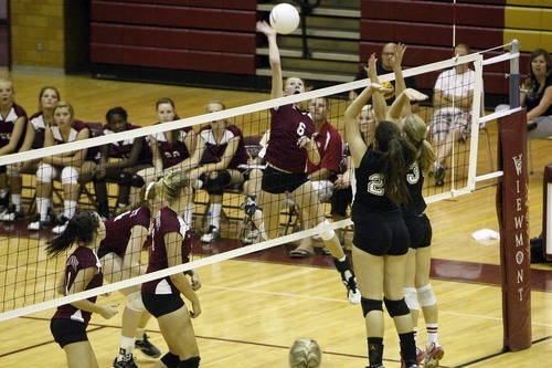 Chris Detrick  |  The Salt Lake Tribune
Viewmont's Shelby Justice (6) spikes the ball as Cottonwood's Jenny Findlay (28) and Cottonwood's Taylor Drowne (35) attempt to block it during the match at Viewmont High School Tuesday August 23, 2011.