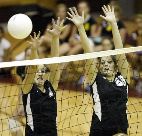 Chris Detrick  |  The Salt Lake Tribune
Cottonwood's Sierra Woolston (4) and Cottonwood's Jenny Findlay (28) go up for a block during the match at Viewmont High School Tuesday August 23, 2011.