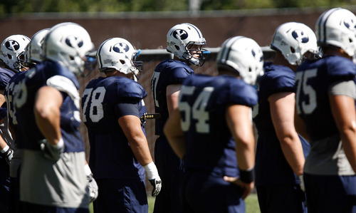 Francisco Kjolseth  |  The Salt Lake Tribune
The offensive line listens to instructions for another drill as BYU holds a practice with many fans in attendance on Tuesday, Aug. 16, 2011.