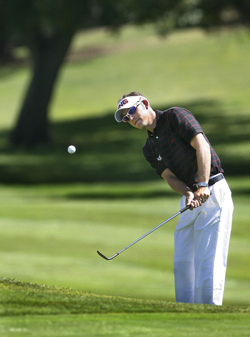 Scott Sommerdorf  |  The Salt Lake Tribune
Clay Ogden pitches to the 13th green on his way to winning the Utah Open at Oakridge Country Club in Farmington, Sunday, August 28, 2011, with score of 17 under.