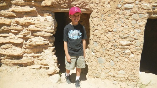 Tom Wharton | The Salt Lake Tribune
Tykler Thompson of Draper comes out of a recreated
ancient American Indian home at Anasazi State Park in Boulder.