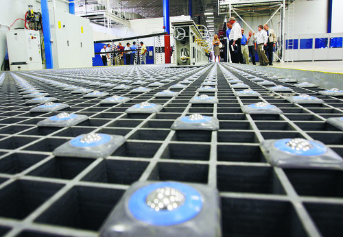 Steve Griffin  |  The Salt Lake Tribune

Guests get a close look at a special floor that allows machinery to slide around during grand opening at ATK's Aircraft Commercial Center of Excellence facility in Clearfield, Utah Monday, August 29, 2011.