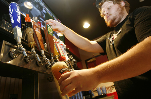 Francisco Kjolseth  |  The Salt Lake Tribune
Beer taps may soon need to also be obscured from the public as Carlos Walter, a supervisor at Wing Nutz in Sugarhouse, pours a customer a beer on Monday, Aug. 29, 2011.