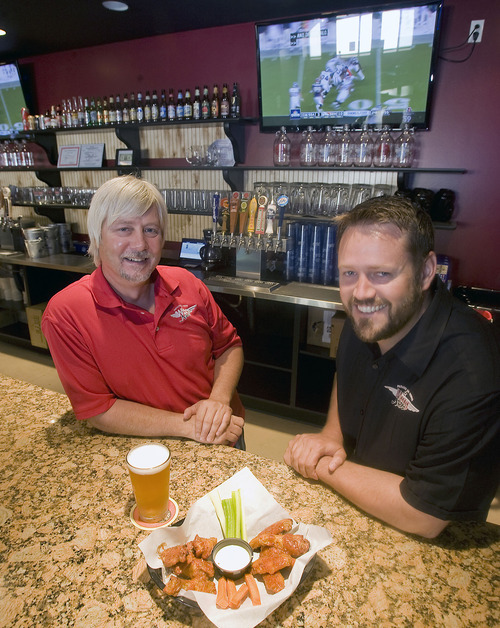 Al Hartmann  |  The Salt Lake Tribune
Will Miller, left, and Will Owens are partners with Wing Nutz, a Utah-based restaurant chain with a dozen locations.   This one is in Sugarhouse.  It's a casual place where familes come to socialize, eat some chicken wings with their beer or soda and watch sports on big screen tv's.    The beer taps and bar behind them will either disappear soon or not be used due to new regulations.  Beer will have to be poured out of sight in a side room, behind a 