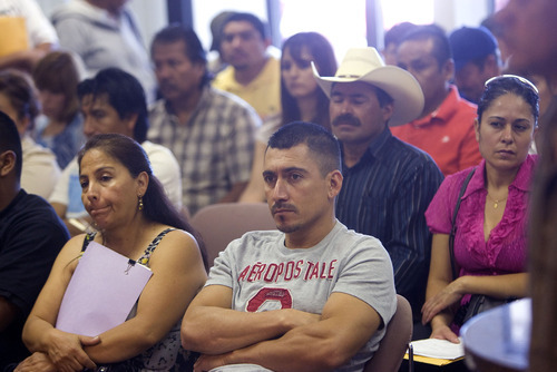 Al Hartmann  |  The Salt Lake Tribune
Folks waiting to do paperwork at the Consulate de Mexico in Salt Lake City listen to Socorro Rovirosa, consul to Mexico, speak about Labor Rights Week, which aims to raise awareness on labor rights.