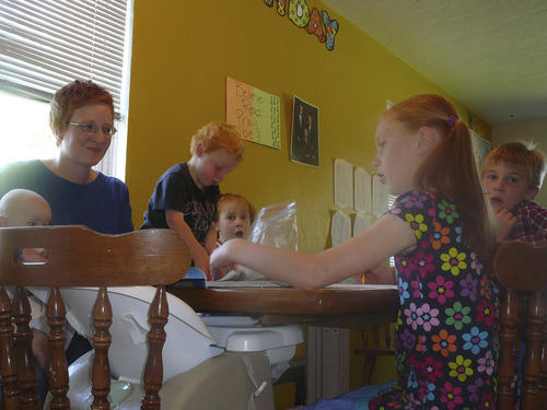 Carol Lindsay | Special to The Tribune
Andrea Young and family studying at the table at their Clearfield home. Andrea, baby Harriet, Eli, Emeline, Cowen and Miriam. More than 1,700 students in Davis County are homeschooled. Many parents like homeschooling for the flexibility it allows.