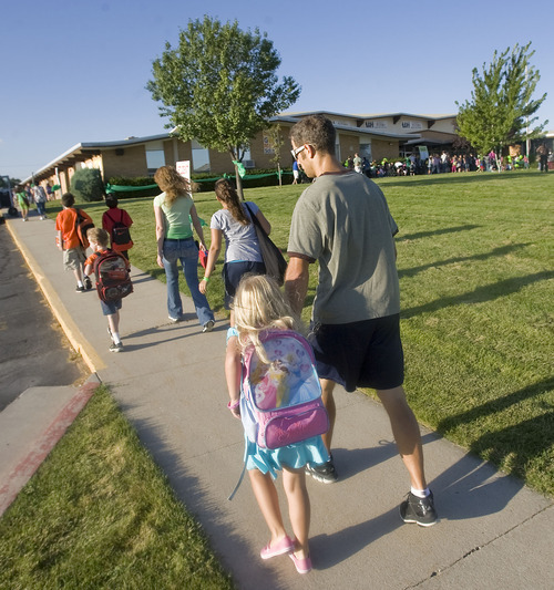 Al Hartmann  |  The Salt Lake Tribune
Parents walk with their children to Arcadia Elementary at 3461 W. 4850 South in Taylorsville on Wednesday, Aug. 31.   Students, parents, school officials and UDOT kicked off 