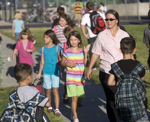 Al Hartmann  |  The Salt Lake Tribune
Parents walk with their children to Arcadia Elementary at 3461 W. 4850 South in Taylorsville on Wednesday, Aug. 31.   Students, parents, school officials and UDOT kicked off 