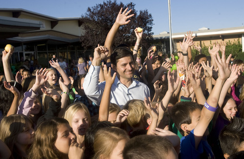 Al Hartmann  |  The Salt Lake Tribune
Robert Hall, Director of Traffic Safety for UDOT, center,  is surrounded by students promising to walk to school at Arcadia Elementary at 3461 West 4850 South in Taylorsville Wednesday morning August 31.   Students, parents, school officials and UDOT kicked off 