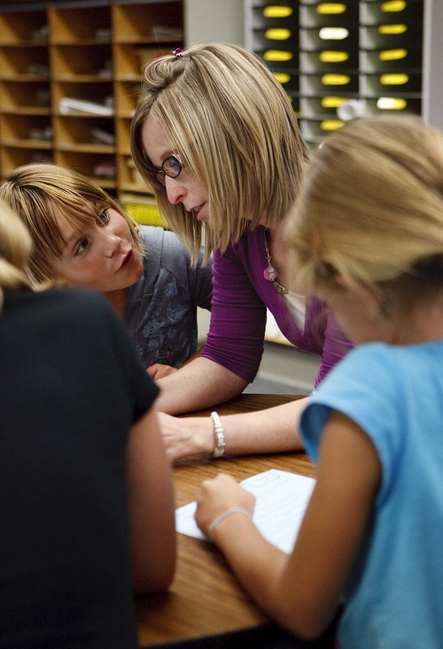 Trent Nelson  |  The Salt Lake Tribune
Classroom aide Allison Beutler works with 4th grade students at Lone Peak Elementary in Salt Lake City, Utah, Wednesday, August 31, 2011. Lone Peak made adequate yearly progress this year under the requirements of No Child Left Behind. After test scores in math and language arts fell short last year, the school used frequent assessments to gauge student learning and also hired new classroom aides.