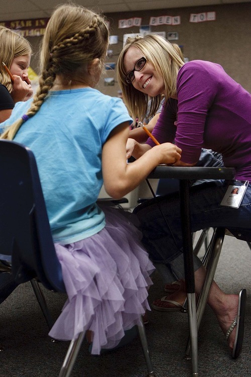 Trent Nelson  |  The Salt Lake Tribune
Classroom aide Allison Beutler works with 4th grade students at Lone Peak Elementary in Salt Lake City, Utah, Wednesday, August 31, 2011. Lone Peak made adequate yearly progress this year under the requirements of No Child Left Behind. After test scores in math and language arts fell short last year, the school used frequent assessments to gauge student learning and also hired new classroom aides.