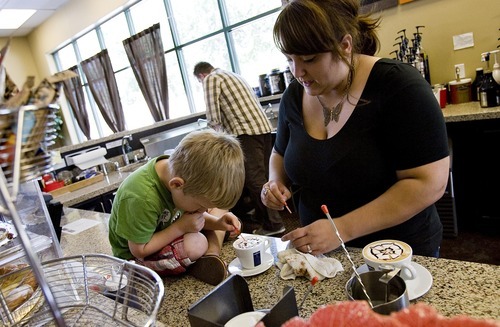 Djamila Grossman  |  The Salt Lake Tribune

Keslie Lyons and her son, Max, 3, make latte art at their family's coffee shop, the Dancing Yeti Coffee, in Draper on Wednesday, Aug. 31, 2011. Lyons and her husband, Tim Lyons, sold around 100 gift certificates on CityDeals.com but they have not been paid. The company's website was disabled Wednesday.