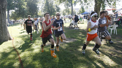Francisco Kjolseth  |  The Salt Lake Tribune
Ski boot racers take off in the first ever Yeti Pass Skootch'n Dash at the Downtown Farmer's on Saturday, September 3, 2011. Costume-clad competitors raced in two hilarious athletic events - a ski boot run (approximately 1K) or a 50-meter snowboard skootch. The fastest racers in each division won prizes including Rossignol skis or snowboard, Smith Optics and other Ski Utah swag. A special award for the best costume, as judged by a panel, won a Ski Utah Yeti Pass good for one day of skiing at every Utah resort during the 2011-12 season. The registration fee to participate was five-dollars per person per race and 50 percent of profits earned will be donated to the Utah Avalanche Center.