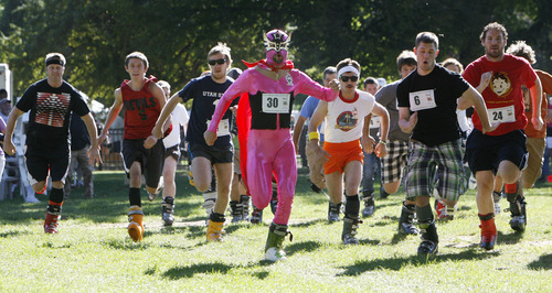 Francisco Kjolseth  |  The Salt Lake Tribune
Shane Thorenson, dressed as Nacho Libre, runs at the front of the ski boot wearing pack while participating in the first ever Yeti Pass Skootch'n Dash  at the Downtown Farmer's on Saturday, September 3, 2011. Costume-clad competitors raced in two hilarious athletic events - a ski boot run (approximately 1K) or a 50-meter snowboard skootch. The fastest racers in each division won prizes including Rossignol skis or snowboard, Smith Optics and other Ski Utah swag. A special award for the best costume, as judged by a panel, won a Ski Utah Yeti Pass good for one day of skiing at every Utah resort during the 2011-12 season. The registration fee to participate was five-dollars per person per race and 50 percent of profits earned will be donated to the Utah Avalanche Center.