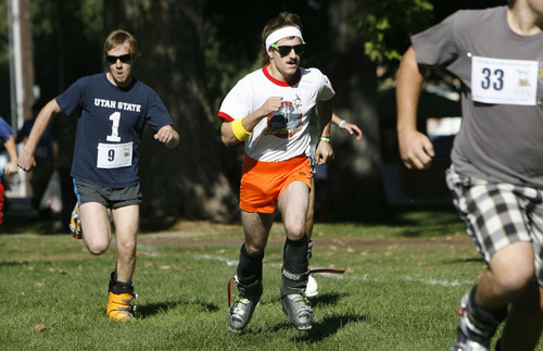 Francisco Kjolseth  |  The Salt Lake Tribune
Hot Dogger, Kyle Wells, center, nears the finish line in the first ever Yeti Pass Skootch'n Dash  at the Downtown Farmer's on Saturday, September 3, 2011.