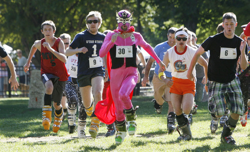 Francisco Kjolseth  |  The Salt Lake Tribune
Shane Thorenson, dressed as Nacho Libre, runs at the front of the ski boot wearing pack while participating in the first ever Yeti Pass Skootch'n Dash  at the Downtown Farmer's on Saturday. Costume-clad competitors raced in two hilarious athletic events - a ski boot run (approximately 1K) or a 50-meter snowboard skootch. The fastest racers in each division won prizes including Rossignol skis or snowboard, Smith Optics and other Ski Utah swag. A special award for the best costume, as judged by a panel, won a Ski Utah Yeti Pass good for one day of skiing at every Utah resort during the 2011-12 season. The registration fee to participate was five-dollars per person per race and 50 percent of profits earned will be donated to the Utah Avalanche Center.