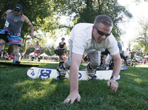 Francisco Kjolseth  |  The Salt Lake Tribune
Brad Hamrick tries a hop-crawl method to get to the finish line in the first ever Yeti Pass Skootch'n Dash  at the Downtown Farmer's on Saturday, September 3, 2011.