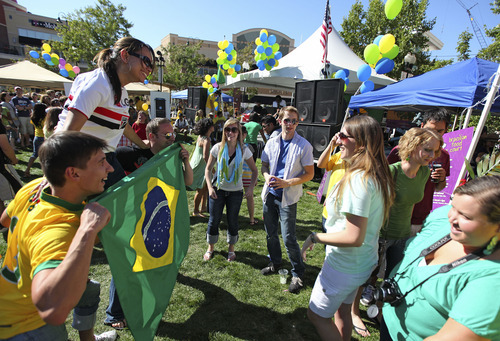 Lennie Mahler  |  The Salt Lake Tribune
Festival-goers hold up the Brazilian flag for a photo during the annual Utah Brazilian Festival at the Gateway Mall, Saturday, Sept. 3, 2011. The festival included capoeira, samba, and live music performances.