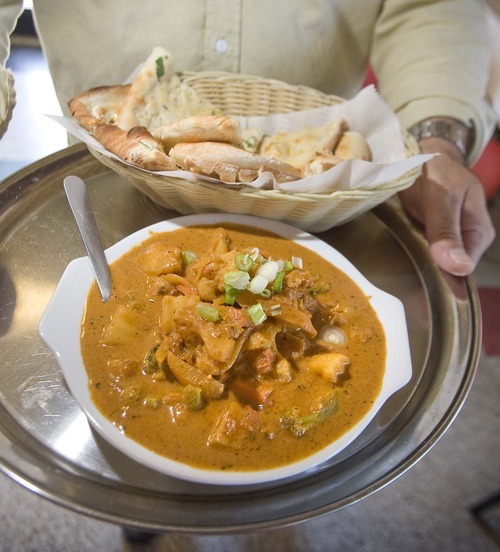 Paul Fraughton  |  The Salt Lake Tribune
Vegetable curry with an order of garlic naan at The Khan Curry House.