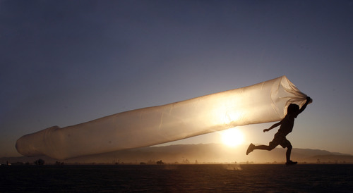 Rick Egan  | The Salt Lake Tribune 

Six-year-old Mare Nakamura, from Japan, runs with a hollow plastic tube, at the Burning Man Festival, in the Black Rock desert, Saturday, Sept. 3, 2011.