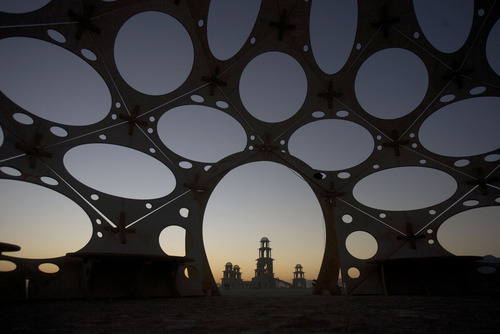 Rick Egan  | The Salt Lake Tribune 

The Temple of Transition seen through an art installation, at dawn in the Black Rock desert, Saturday, Sept. 3, 2011.  The temple is composed of six structures, the largest standing 120 feet high. The temple project was created by by Chris Hankins, Diarmaid Horkan and the International Art Megacrew.
