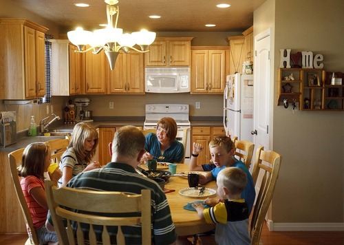 Trent Nelson  |  The Salt Lake Tribune
The Burton family gathers for dinner Aug. 25. The Burtons are trying to sell their home in Tooele because of a job transfer. Despite adding more than $20,000 in improvements since they purchased the home in 2005, the Burtons are now asking only what they paid for the home. From left are Kaitlyn, Emily, Scott, Angela, Zachary and Jeffrey Burton.