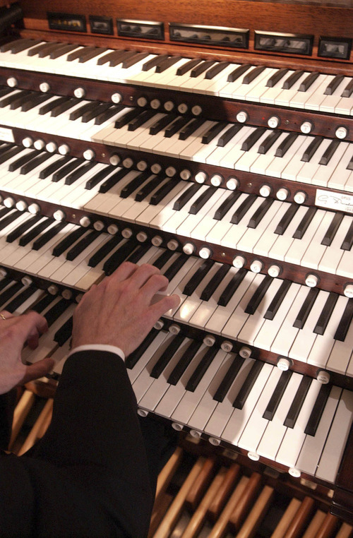 Francisco Kjolseth | The Salt Lake Tribune
Tabernacle organist Richard Elliott works five separate keyboards while practicing for a previousMadeleine Organ Festival concert.