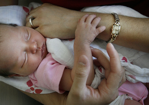 Scott Sommerdorf  |  The Salt Lake Tribune                 
Mallory Wahlstrom Wright's infant daughter Molly rests in her arms near the wristwatch that is Mallory's favorite remembrance of her grandmother. The watch has since stopped keeping time, but that increases the meaning it has for her and the memory of her grandmother, who died in the 9-11 terrorist attacks. Mallory Wahlstrom Wright is now married and gave birth to her first child, on Friday. Aug. 26, 2011.