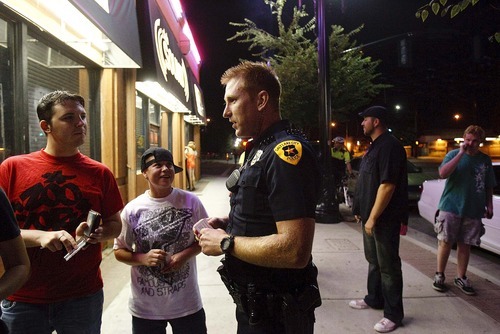 Trent Nelson  |  The Salt Lake Tribune
Salt Lake City police Officer Kevin Stayner hands out contact cards Friday to patrons at Club Sound in Salt Lake City. The police department had a visible presence in the community Friday night, after three assaults on gay men in the past two weeks.