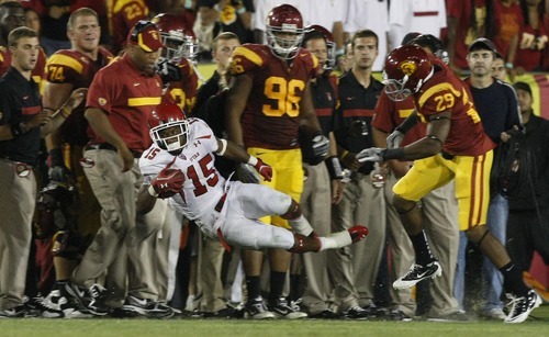 Chris Detrick  |  The Salt Lake Tribune
Utah Utes running back John White IV (15) is pushed out of bounds by USC Trojans safety Jawanza Starling (29) during the second half of the game at the Los Angeles Memorial Coliseum Saturday September 10, 2011.