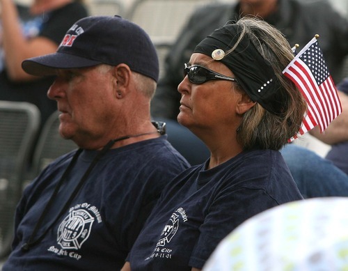 Leah Hogsten  |  The Salt Lake Tribune
Salt Lake City firefighter/EMT Brenda Robbs and her husband Ray Robbs, a retired captain with SLCFD watch as a bell is rung Saturday, September 10 2011 in Ogden, in honor of those firefighters who have lost their lives in the line of duty.  The 2011 Fire Ride for motorcyclists commemorated the tenth anniversary of the World Trade Center attacks by riding from Sandy to Ogden, Utah.