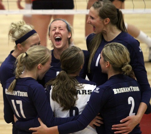 Rick Egan  | The Salt Lake Tribune 

BYU celebrates the score that gave them the win in game one,  in volleyball action, Utah vs. BYU, in Salt Lake City, Saturday, September 10, 2011.